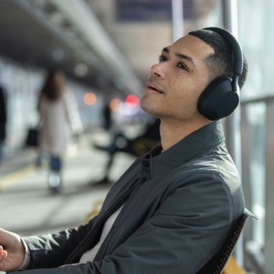Gamer focused on the action in a futuristic virtual world with high-quality gaming headphones.