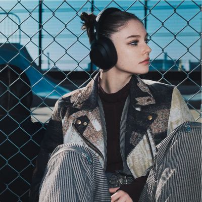 Gamer focused on the action in a futuristic virtual world with high-quality gaming headphones.